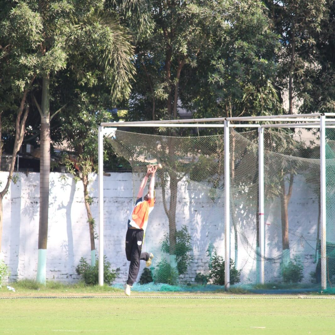 Player jumping for catch at long on – nervous before a cricket match